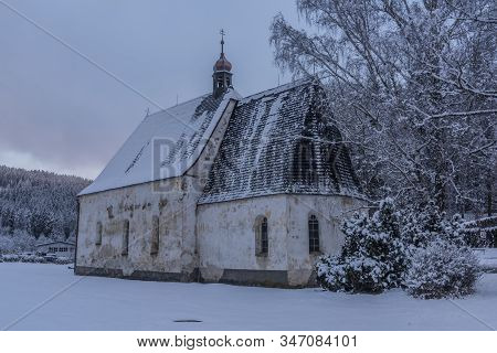 Blue Cloudy Morning With Fog And Church In Loucovice Village