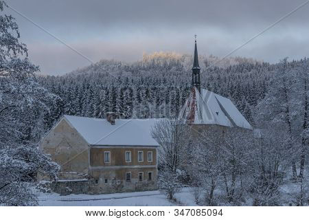Blue Cloudy Morning With Fog And Church In Loucovice Village