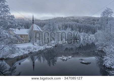 Blue Cloudy Morning With Fog And Church In Loucovice Village