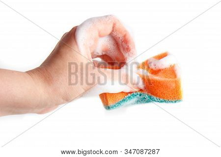 Hand Compresses A Soapy Sponge For Washing Dishes On A White Background