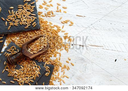 Raw Kamut Grain With A Spoon On A Table