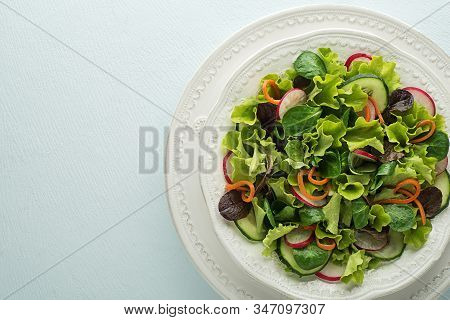 Healthy Green Salad With Fresh Vegetables On Blue Table Background