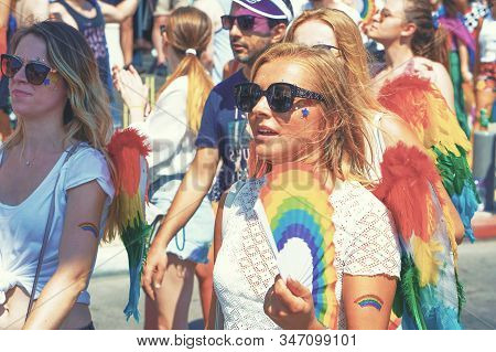 The Annual Parade Lgbt. Lesbians Walking In The Gay Pride Parade. Parade Of Tolerance. Rainbow Flags
