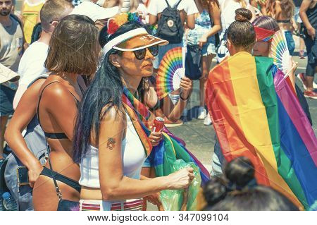 The Annual Parade Lgbt. Lesbians Walking In The Gay Pride Parade. Parade Of Tolerance. Rainbow Flags