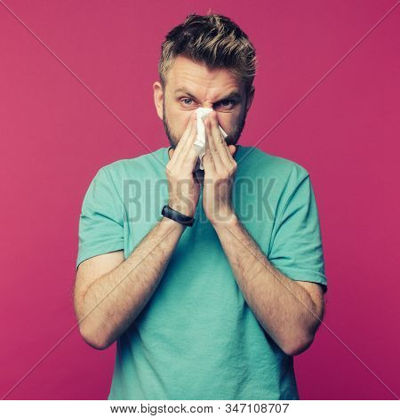 Studio Picture From A Young Man With Handkerchief. Sick Guy Isolated Has Runny Nose. Man Makes A Cur