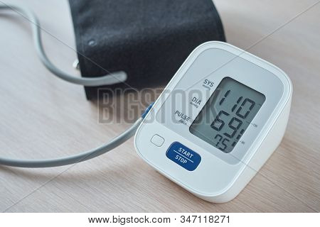 Digital Blood Pressure Monitor On The Table, Closeup. Helathcare And Medical Concept