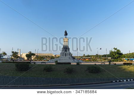 Statue Of General Maximo Gomez Against A Blue Cloudy Sky. Maximo Gomez Is One Of The Leaders Of The 