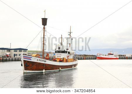 Husavik, Iceland - September 2019: Traditional old wooden fisherman boats used for whale watching in Husavik harbor