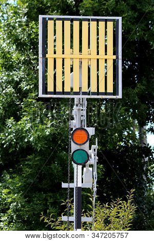 Railway Trackside Red And Green Traffic Signal Lights Below Signal Sign Mounted On Metal Pole At Loc