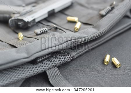 9mm Bullets And Pistol Lie On A Black Tactical Backpack