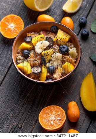 Quinoa Fruit Salad. Fresh Quinoa Organic Fruit Salad In Bowl On Wooden  Background. Helthy Superfood