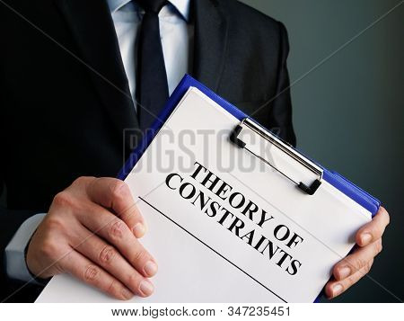 Businessman Holds Toc Theory Of Constraints Papers.