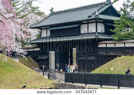 Hirosaki Park In Springtime Cherry Blossom Season Sunny Day At Otemon Gate Entrance. Visitors Enjoy 