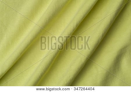 Close-up Fragment Of A Beautiful Yellow Cotton Fabric. Concept Of High-quality Raw Materials For Tai