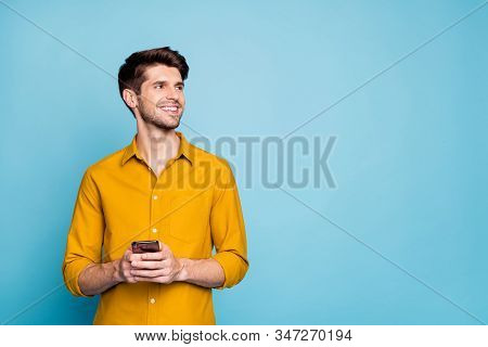 Photo Of Toothy Handsome Huy Wearing Yellow Shirt Holding Telephone With Hands Smiling Beaming At Em