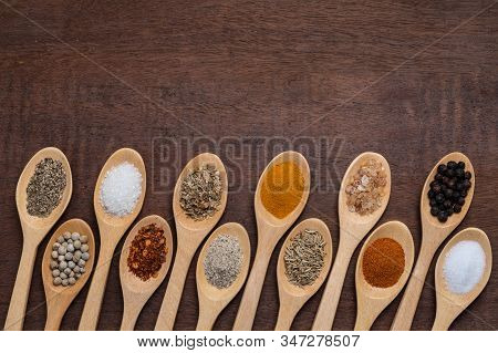 Various Spices In Wooden Spoon On Wood Table Background, Sugar, Pepper, Salt, Turmeric, Rosemary, Or