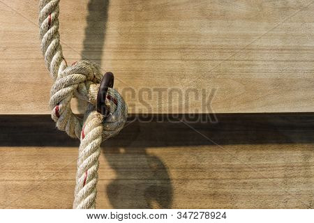 Knop Of Big Rope On Wood Background.