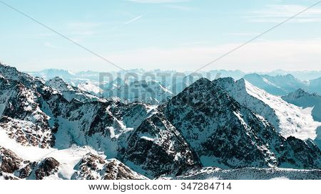 Blue Tinted High Rocky Mountain Landscape. Beautiful Scenic View Of Mount. Alps Ski Resort. Austria,