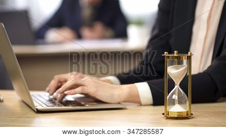 Female Working On Laptop At Office, Hourglass Measuring Time, Efficiency At Work