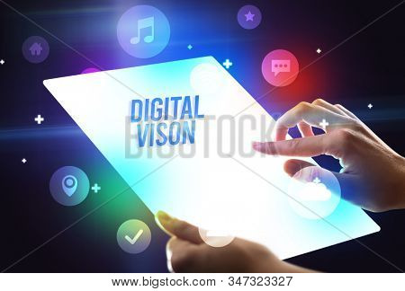 Holding futuristic tablet with DIGITAL VISON inscription, new technology concept
