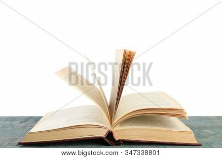 Open Old Hardcover Book On Wooden Table