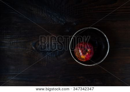 Art Concept Of The Problem Of Food Consumption. Red Rotten Apple On A Plate With Tehstil On A Wooden