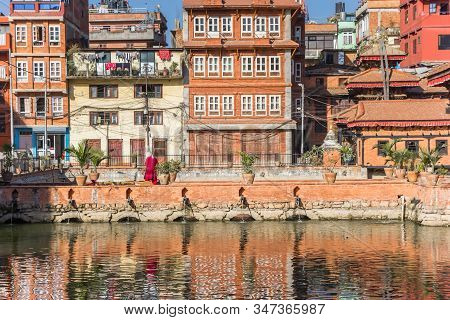 Colorful Houses Reflecting In The Pond At The Pimbahal Pokhari Krishna Temple In Patan, Nepal