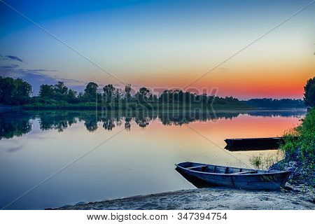 Tranquil And Peaceful Picturesque Landscape Of The Pripyat River With Wooden Boat At Foreground. Lak