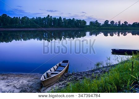 Tranquil And Peaceful Picturesque Landscape Of The Pripyat River With Wooden Boat At Foreground. Lak