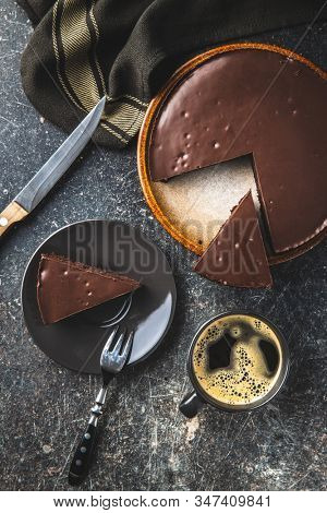Chocolate brownies cake and coffee cup on old kitchen table.
