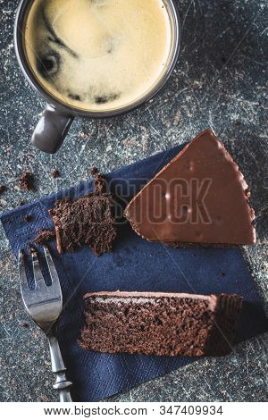 Chocolate brownies cake and coffee cup on old kitchen table.
