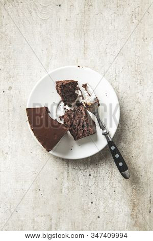 Chocolate brownies cake on old kitchen table.