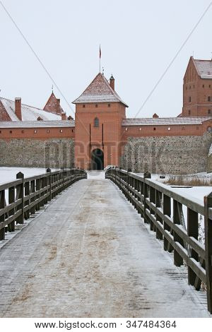 Gothic Red Brick Trakai Castle In Winter Time, In The Middle Of Frozen Lake, Lithuania