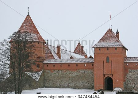 Gothic Red Brick Trakai Castle In Winter Time, In The Middle Of Frozen Lake, Lithuania