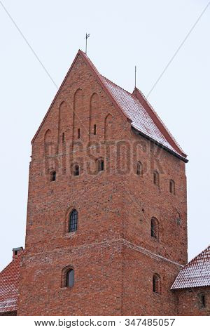 Gothic Red Brick Trakai Castle In Winter Time, In The Middle Of Frozen Lake, Lithuania
