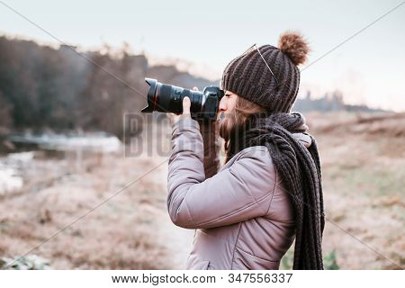 Female Photographer Talking Pictures Outdoor With Camera. Nature Photography