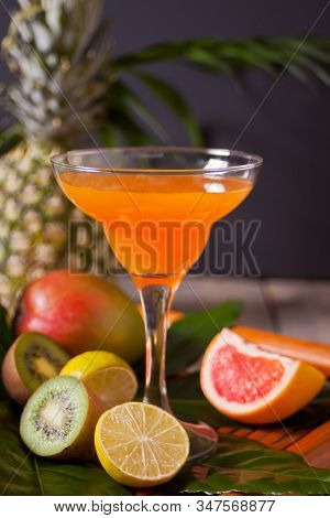 Glass Of Tropical Exotic Multifruit Juice Cocktail Drink With Fruits Nearby