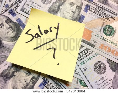 American Cash Money And Yellow Paper Note With Text Salary With Question Mark In Black Color Aerial 