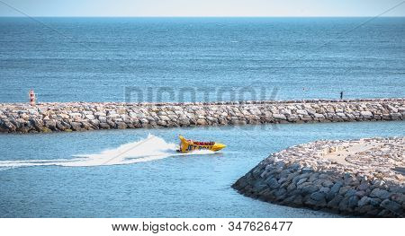 Albufeira, Portugal - May 3, 2018: Jetboat For Tourists Entering The Harbor At Full Speed On A Sprin