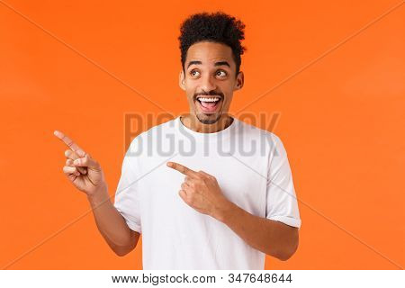 Excited, Happy Smiling African-american Man In White T-shirt, Looking Wondered And Astonished At Awe
