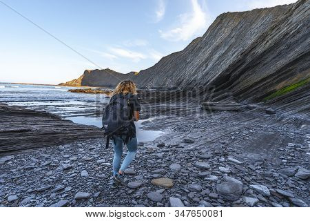 Deba, Gipuzkoa / Spain »; January 26, 2020: A Young Woman Walking The Sakoneta Coast Geopark One Mor