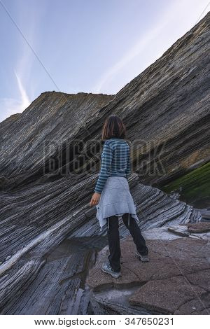 Deba, Gipuzkoa / Spain »; January 26, 2020: A Young Woman Looking At The Sakoneta Coast Geopark One 