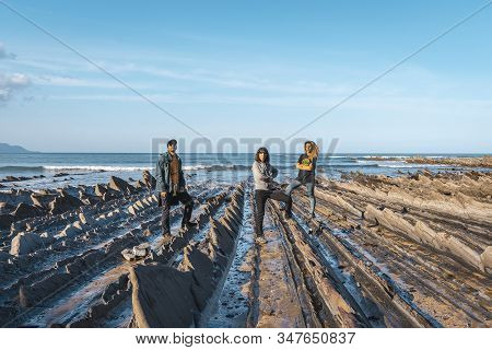 Deba, Gipuzkoa / Spain »; January 26, 2020: Three Young People On The Coast Of Sakoneta Saluting