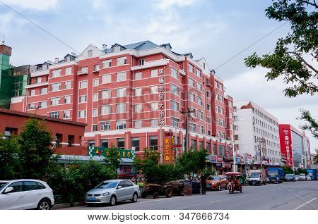 China, Heihe, July 2019: Big Red Building, Streets Of The Chinese City Of Heihe In The Summer