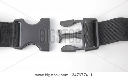Black Plastic Fastex Clip For Backpacks On A White Background. Items Of Clothing And Equipment