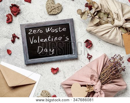 Zero Waste Valentines Day Concept. Eco-friendly Gift Cloth Wrapping In Furoshiki Style And Chalkboar