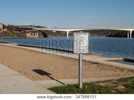 Sign With Beach Rules At Public Swimming Area At Lake Shore On A Sunny Day With Blue Sky. Highway Br