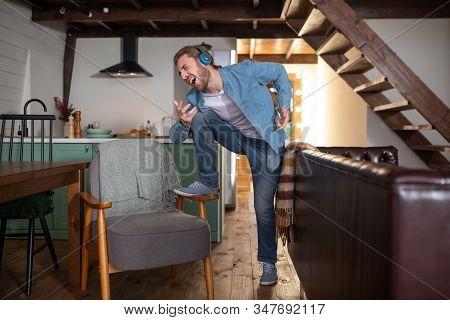 Emotional Man Imagining Himself A Frontman Of The Rock Band