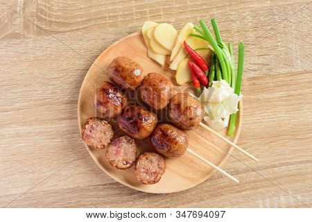 Thai Sausage Or Isan Sausage (grilled Fermented Rice With Pork) Eating With Fresh Ginger, Cabbage An