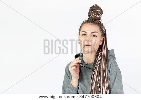 A Beautiful Girl With Pink Afro Or Zizi Pigtails Looks Thoughtfully At The Camera And Holds Glasses 